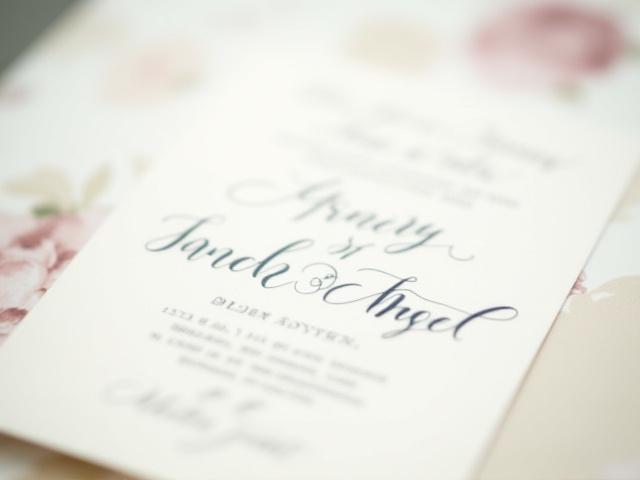 A beautifully hand-addressed wedding invitation set with floral accents
